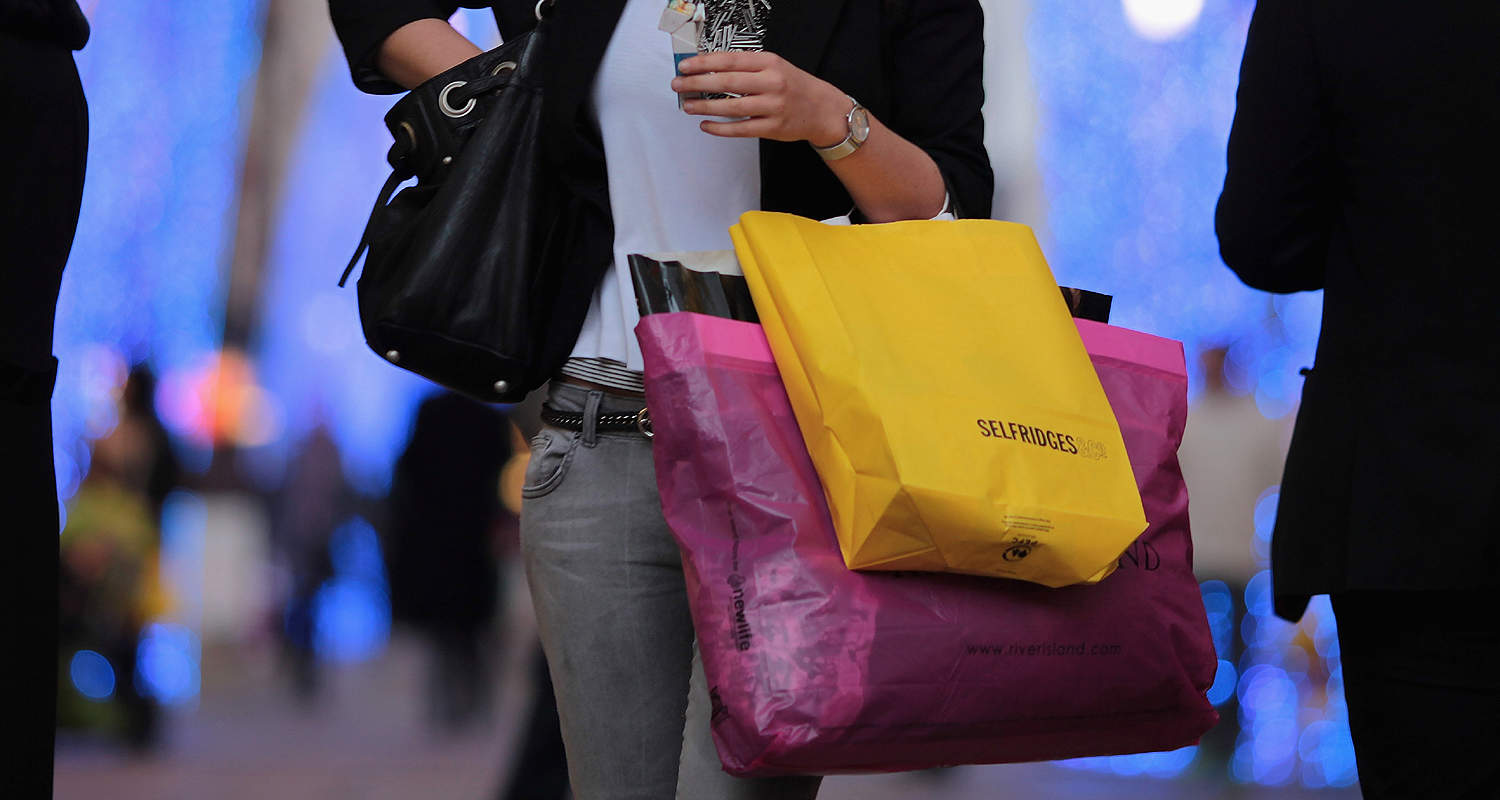 LONDON, ENGLAND - DECEMBER 14:  A woman carries shopping bags off New Bond Street on December 14, 2009 in London, England. High street stores are expecting a bumper Christmas this year despite the economic dowturn, with shoppers spending around GBP £120 million in the past two days alone.  (Photo by Dan Kitwood/Getty Images)